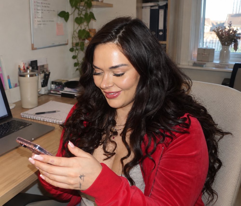 Natasha working on her phone